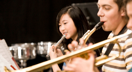 Middle School students playing band instruments 